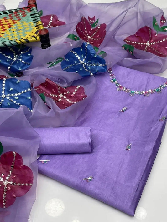 Elegant purple unstitched dress set with floral embroidery and matching dupatta, perfect for weddings.