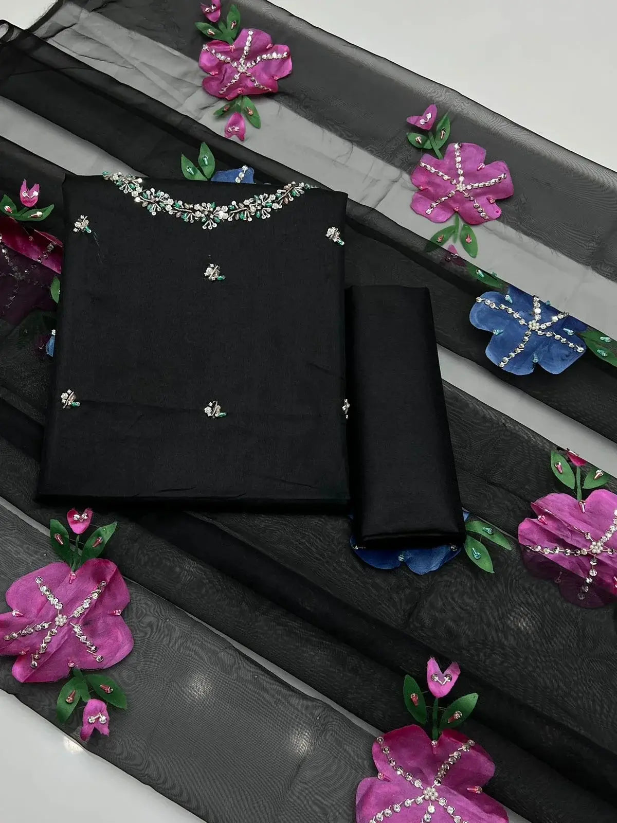 Wedding Collection unstitched dress set with black fabric and colorful floral embroidery.